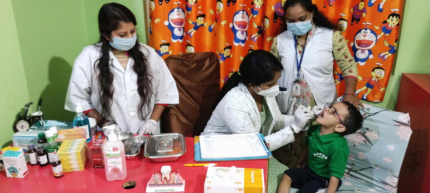 pediatrician assess child physical, developmental, and emotional health